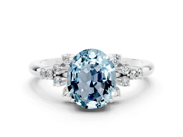 Silver Oval Cut Aquamarine Ring with Side Stones and Four-Prong Setting
