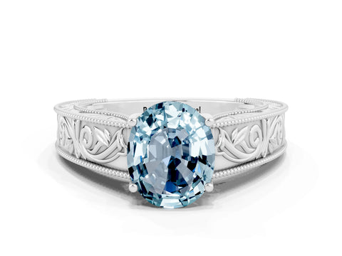 White gold Oval Cut Aquamarine Solitaire Ring with Engraved Band and Four-Prong Setting