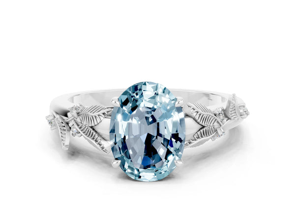 Silver Oval Cut Aquamarine Solitaire Ring with Leaf Motif Band and Four-Prong Setting