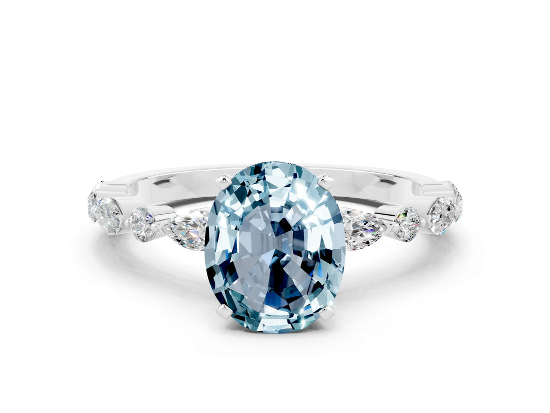 White gold Oval Cut Aquamarine Solitaire with Side Stones on a Pavé Band and Four-Prong Setting