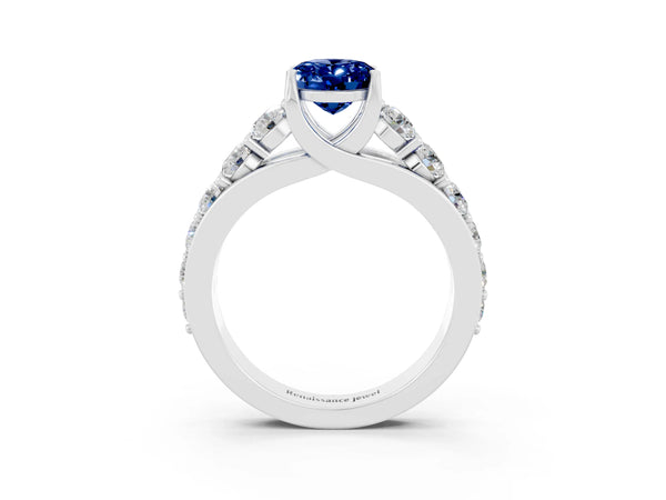 Silver Oval Cut Blue Sapphire Engagement Ring with Pavé Band and Four-Prong Setting
