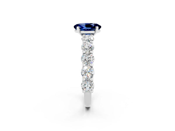 Silver Oval Cut Blue Sapphire Prong Setting with Side Stones on a Pave Band
