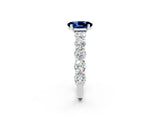 White gold Oval Cut Blue Sapphire Prong Setting with Side Stones on a Pave Band_2
