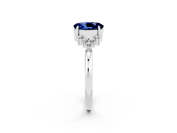 Silver Oval Cut Blue Sapphire Ring with Side Stones and Four-Prong Setting
