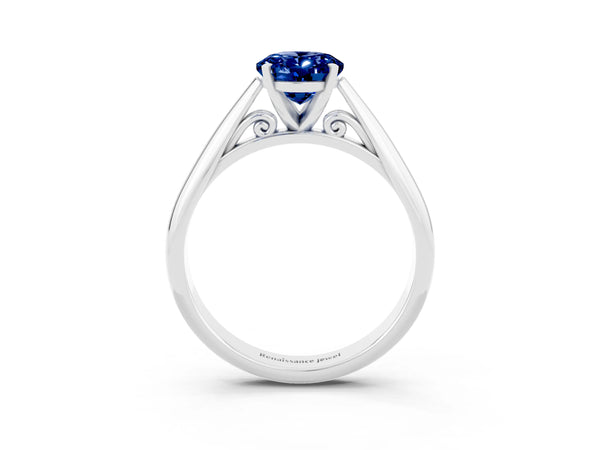 Platinum Oval Cut Blue Sapphire Solitaire Engagement Ring with Cathedral Setting and Four-Prong Mount