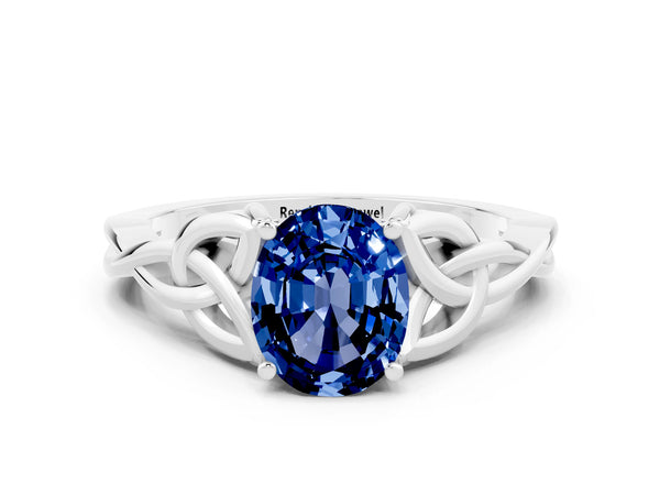 White gold Oval Cut Blue Sapphire Solitaire Engagement Ring with Celtic Knot Band and Four-Prong Setting