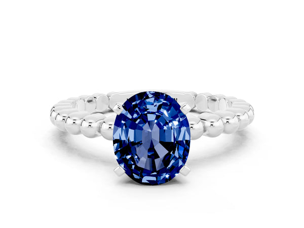 Platinum Oval Cut Blue Sapphire Solitaire Ring with Beaded Band and Prong Setting