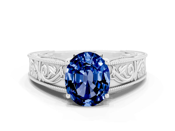 White gold Oval Cut Blue Sapphire Solitaire Ring with Engraved Band and Four-Prong Setting