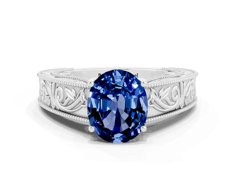 White gold Oval Cut Blue Sapphire Solitaire Ring with Engraved Band and Four-Prong Setting