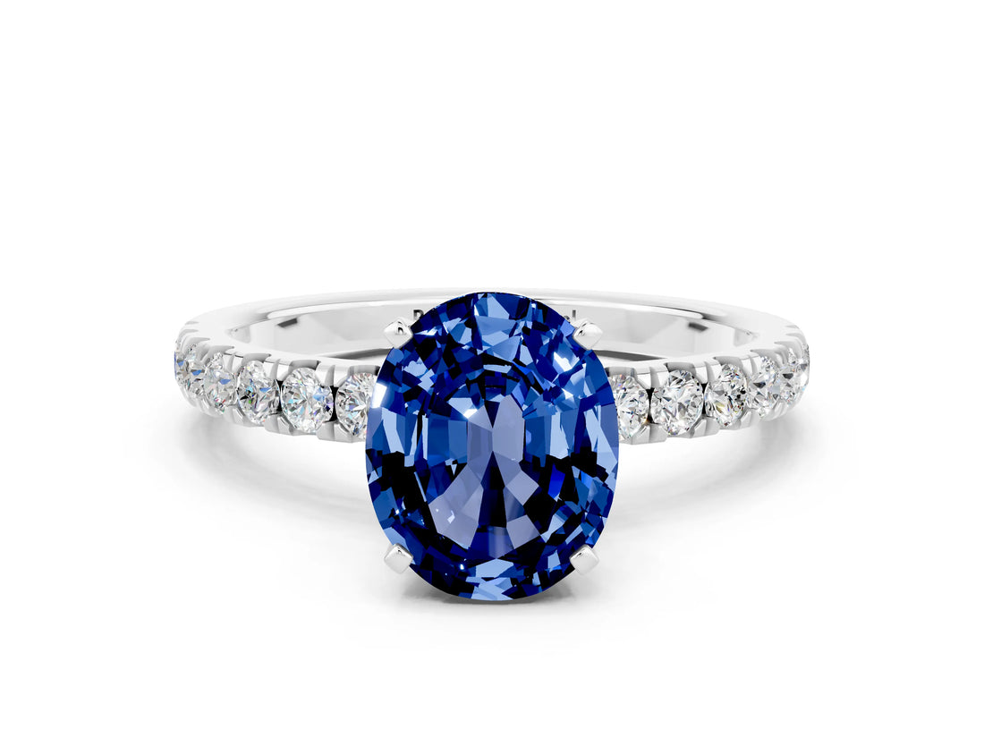 White gold Oval Cut Blue Sapphire Solitaire Ring with Pavé Accents and Four-Prong Setting