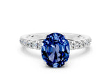 White gold Oval Cut Blue Sapphire Solitaire Ring with Pavé Accents and Four-Prong Setting