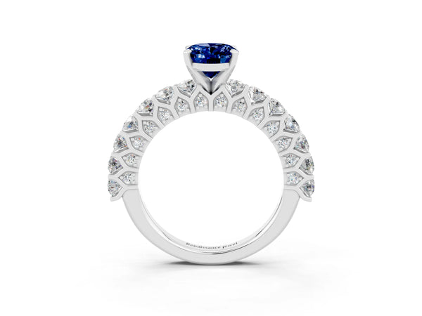 Platinum Oval Cut Blue Sapphire Solitaire Ring with Shared Prong Pavé Band and Four-Prong Setting