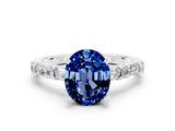 White gold Oval Cut Blue Sapphire Solitaire with Side Baguettes and Channel Set Band