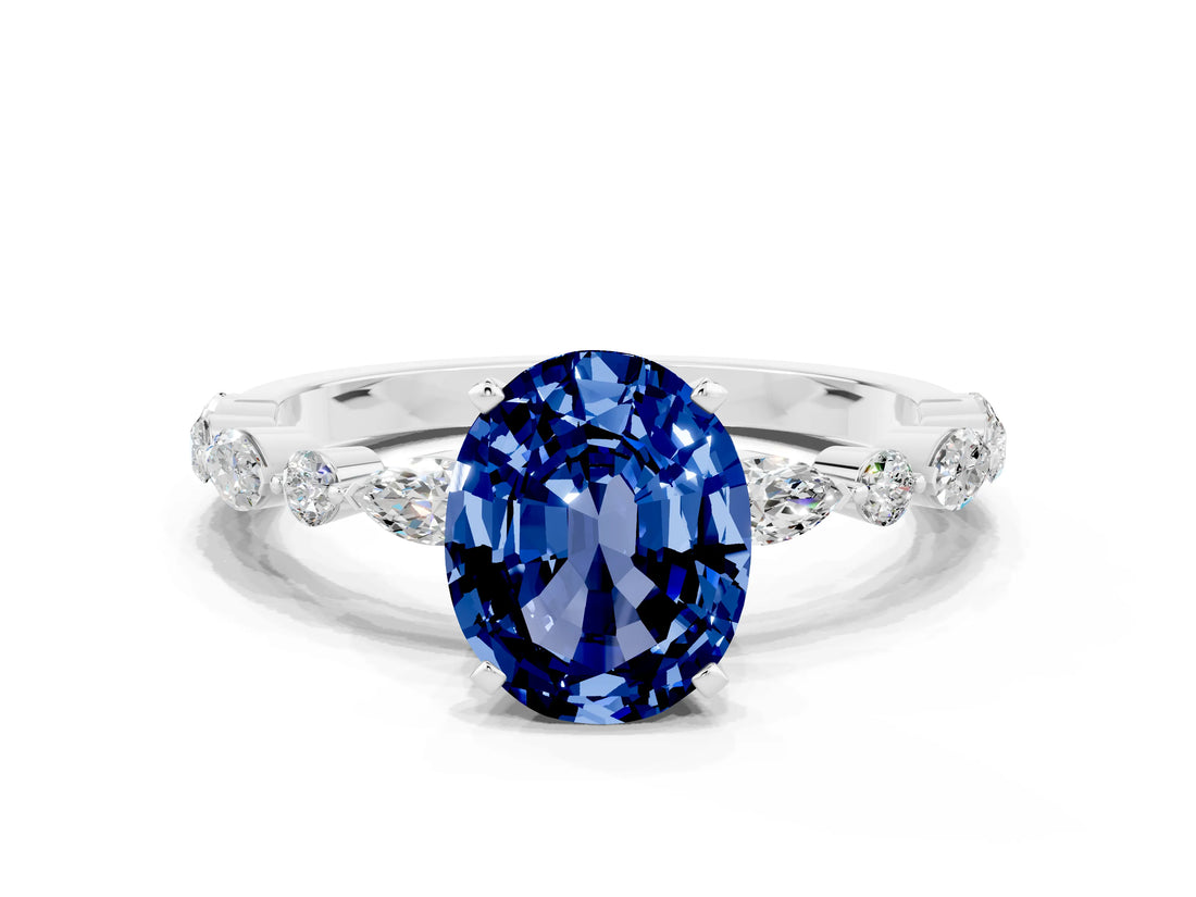 White gold Oval Cut Blue Sapphire Solitaire with Side Stones on a Pavé Band and Four-Prong Setting