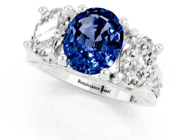 Platinum Oval Cut Blue Sapphire Three-Stone Ring with Channel Set Band and Four-Prong Setting