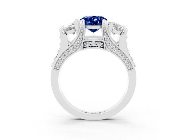 Platinum Oval Cut Blue Sapphire Three-Stone Ring with Channel Set Band and Four-Prong Setting