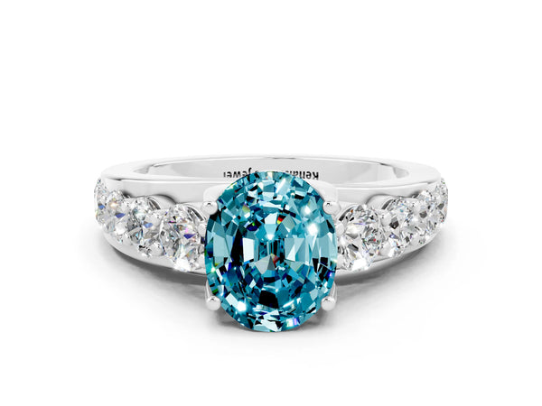 Silver Oval Cut Blue Topaz Engagement Ring with Pavé Band and Four-Prong Setting