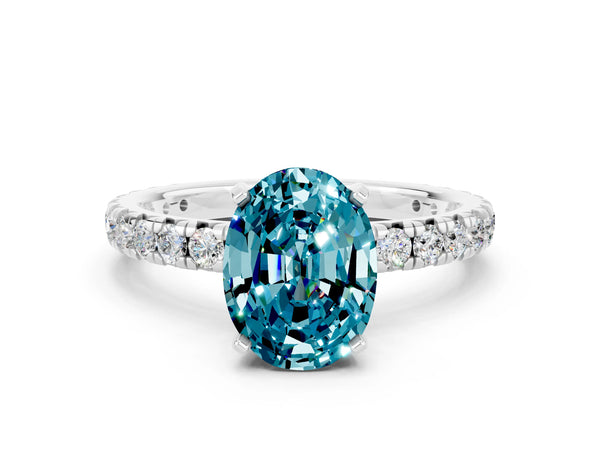 Platinum Oval Cut Blue Topaz Pavé Solitaire Ring with Round Band and Prong Setting