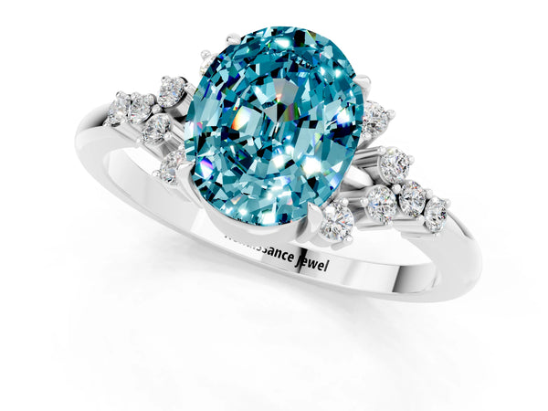 Platinum Oval Cut Blue Topaz Ring with Side Stones and Four-Prong Setting