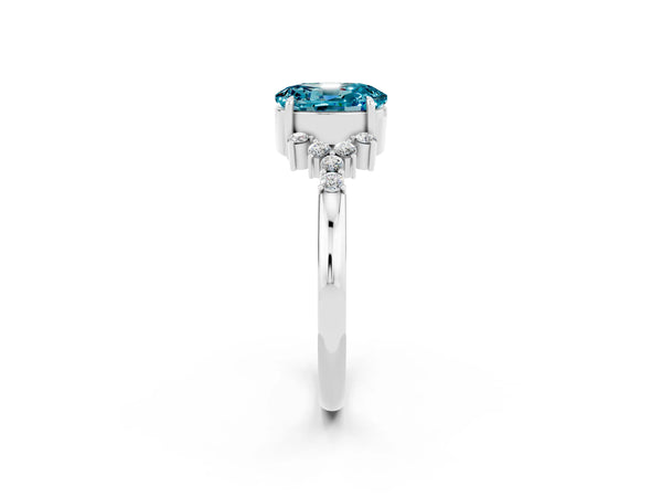 Platinum Oval Cut Blue Topaz Ring with Side Stones and Four-Prong Setting