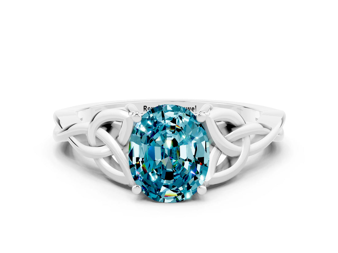 White gold Oval Cut Blue Topaz Solitaire Engagement Ring with Celtic Knot Band and Four-Prong Setting