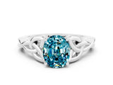 White gold Oval Cut Blue Topaz Solitaire Engagement Ring with Celtic Knot Band and Four-Prong Setting