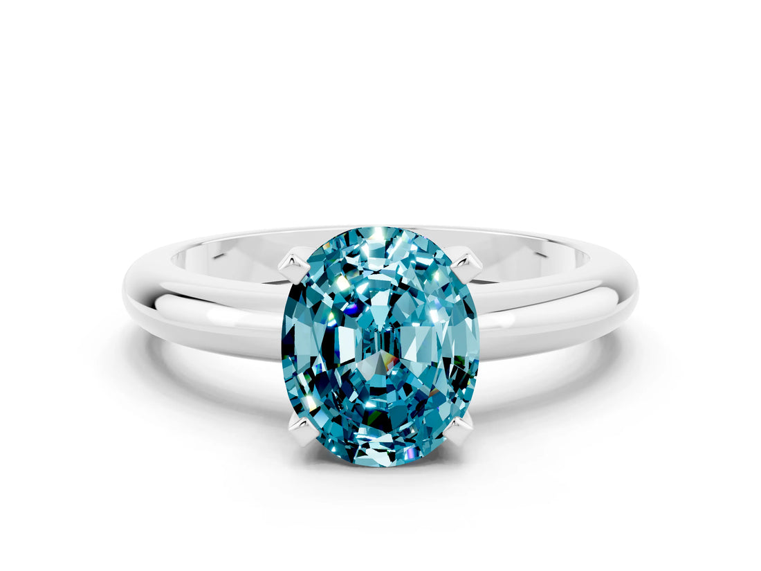 White gold Oval Cut Blue Topaz Solitaire Engagement Ring with Round Band and Four-Prong Setting