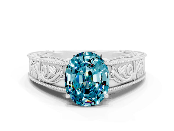 White gold Oval Cut Blue Topaz Solitaire Ring with Engraved Band and Four-Prong Setting