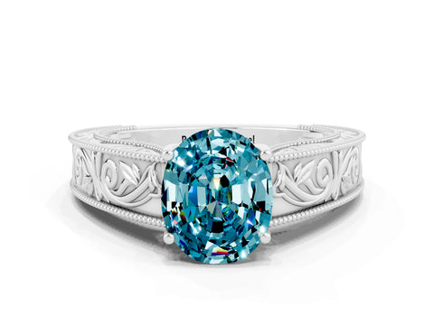White gold Oval Cut Blue Topaz Solitaire Ring with Engraved Band and Four-Prong Setting