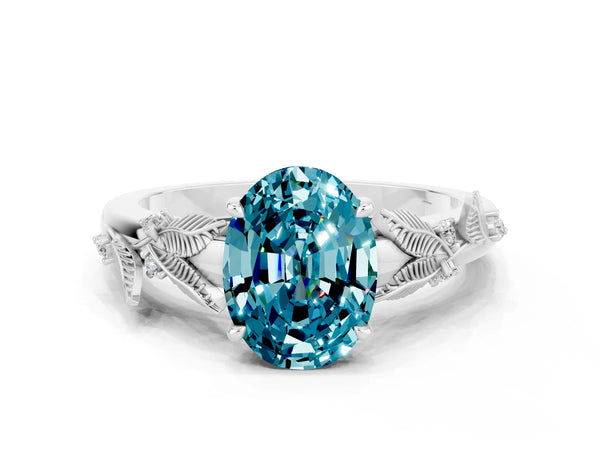 White gold Oval Cut Blue Topaz Solitaire Ring with Leaf Motif Band and Four-Prong Setting