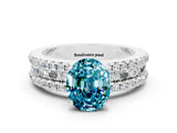 White gold Oval Cut Blue Topaz Solitaire Ring with Pavé and Channel Set Band