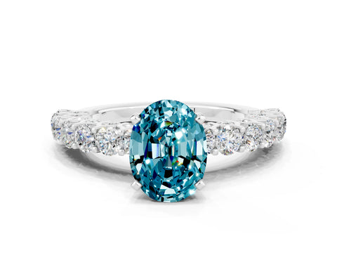 White gold Oval Cut Blue Topaz Solitaire Ring with Shared Prong Pavé Band and Four-Prong Setting