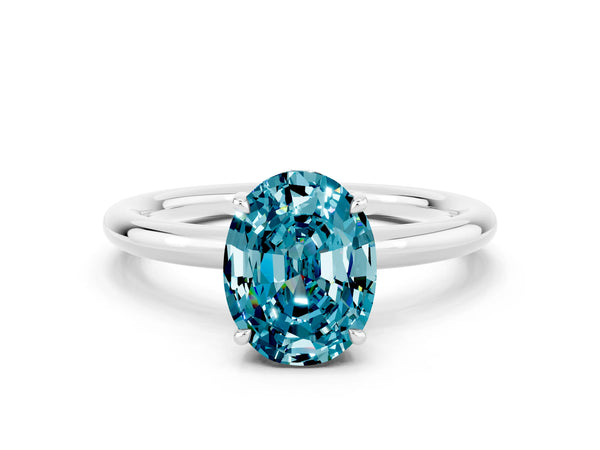 Platinum Oval Cut Blue Topaz Solitaire Ring with Thin Band and Four-Prong Setting