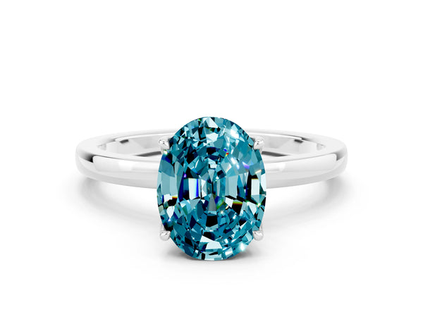 Platinum Oval Cut Blue Topaz Solitaire Ring with Thin Band and Prong Setting