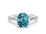 White gold Oval Cut Blue Topaz Solitaire with Side Baguettes and Channel Set Band
