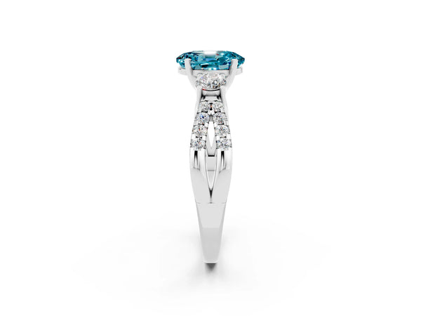 Platinum Oval Cut Blue Topaz Three-Stone Ring with Pavé Split Shank and Four-Prong Setting