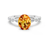 White gold Oval Cut Citrine Solitaire with Side Stones on a Pavé Band and Four-Prong Setting