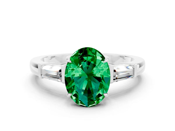 Platinum Oval Cut Emerald Three-Stone Ring with Tapered Baguette Side Stones and Prong Setting