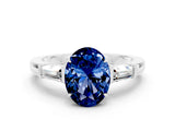 White gold Oval Cut Cut Diamond Ring with Tapered Baguette Side Stones in Four-Prong Setting