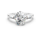 White gold Oval Cut Cut Diamond Ring with Tapered Baguette Side Stones in Four-Prong Setting
