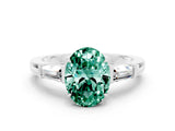 White gold Oval Cut Cut Diamond Ring with Tapered Baguette Side Stones in Four-Prong Setting