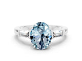 White gold Oval Cut Cut Diamond Ring with Tapered Baguette Side Stones in Four-Prong Setting