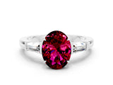 White gold Oval Cut Cut Diamond Ring with Tapered Baguette Side Stones in Four-Prong Setting