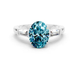 White gold Oval Cut Cut Diamond Ring with Tapered Baguette Side Stones in Four-Prong Setting