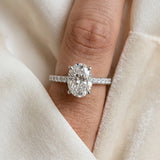 White gold Oval Cut Diamond Brilliant Solitaire Ring with Pavé Band and Four-Prong Setting