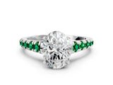 White gold Oval Cut Diamond Cathedral Solitaire Ring with Round with Emerald side stone Pavé Band