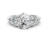 White gold Oval Cut Diamond Cluster Ring with Round Accent Stones and Prong Setting on a Classic Band_96
