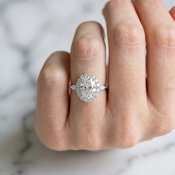 White gold Oval Cut Diamond Halo Ring with Pear Side Stones and Prong Setting