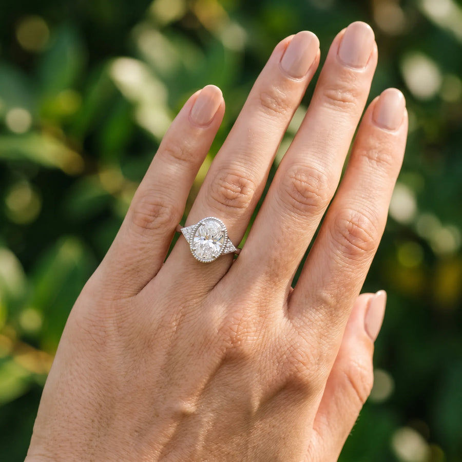 White gold Oval Cut Diamond Halo Ring with Tapered Band and Four-Prong Setting