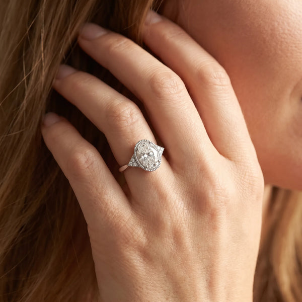 White gold Oval Cut Diamond Halo Ring with Tapered Band and Four-Prong Setting